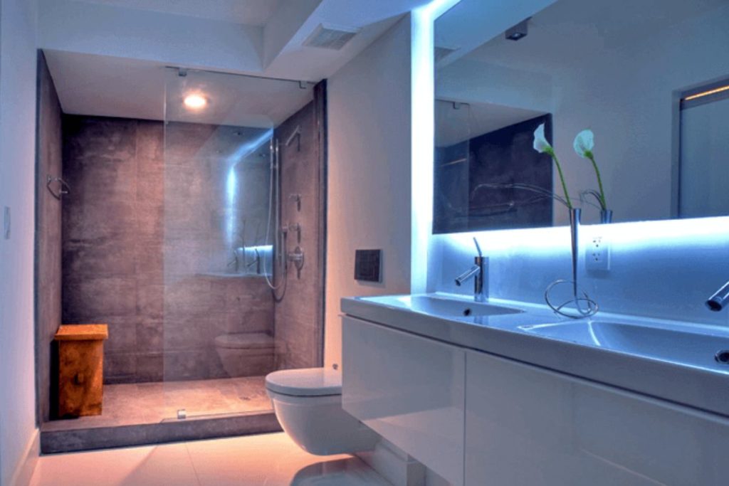 Banheiros Moderno iluminado com fita de Led no espelho.